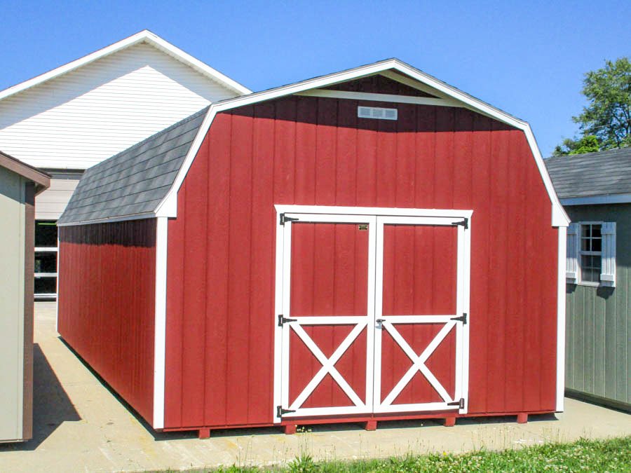 Red Gambrel barn with white trim and double doors
